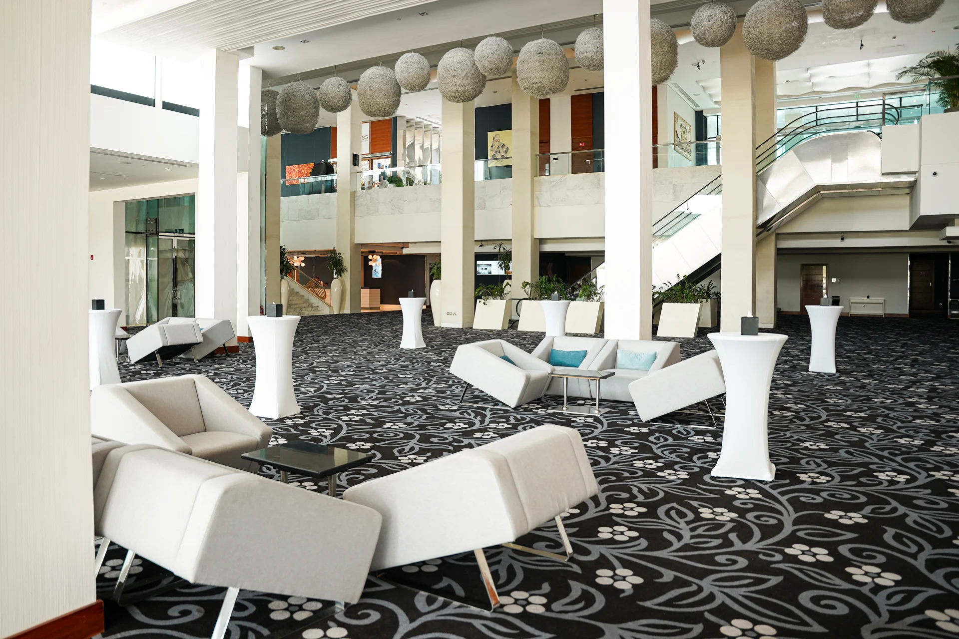 Fairmont Bab Al Bahr pre-function lounge with event cocktail tables.