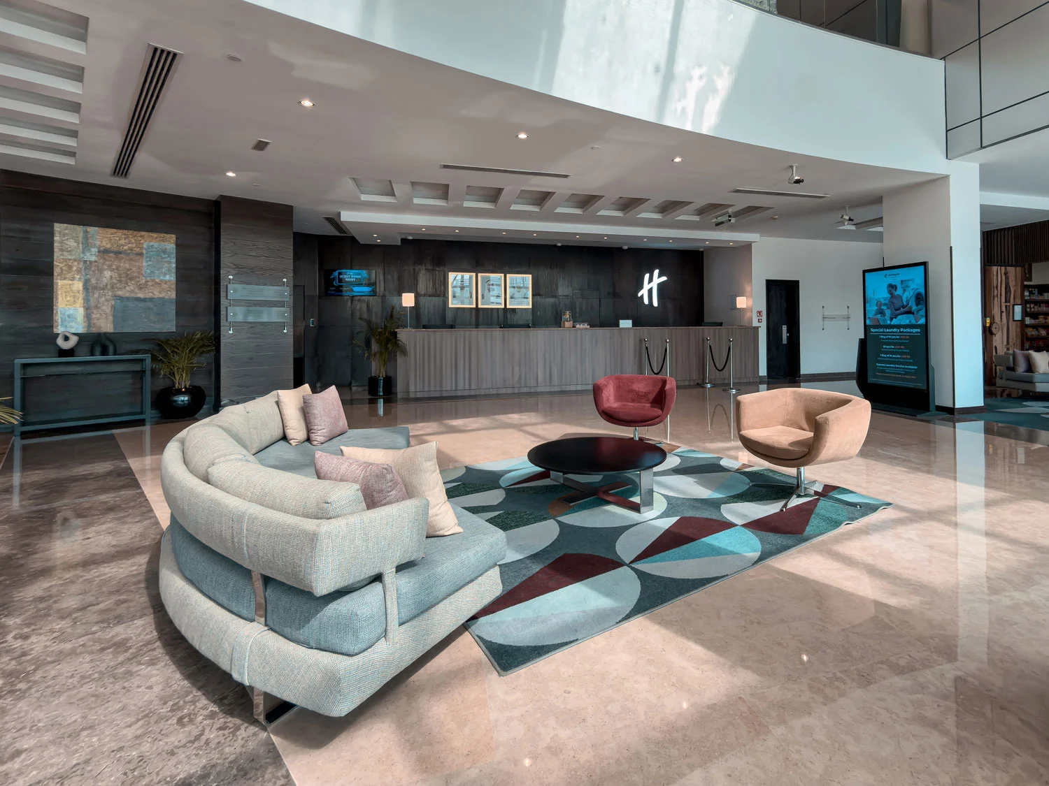 Holiday Inn Abu Dhabi lobby reception and seating area.