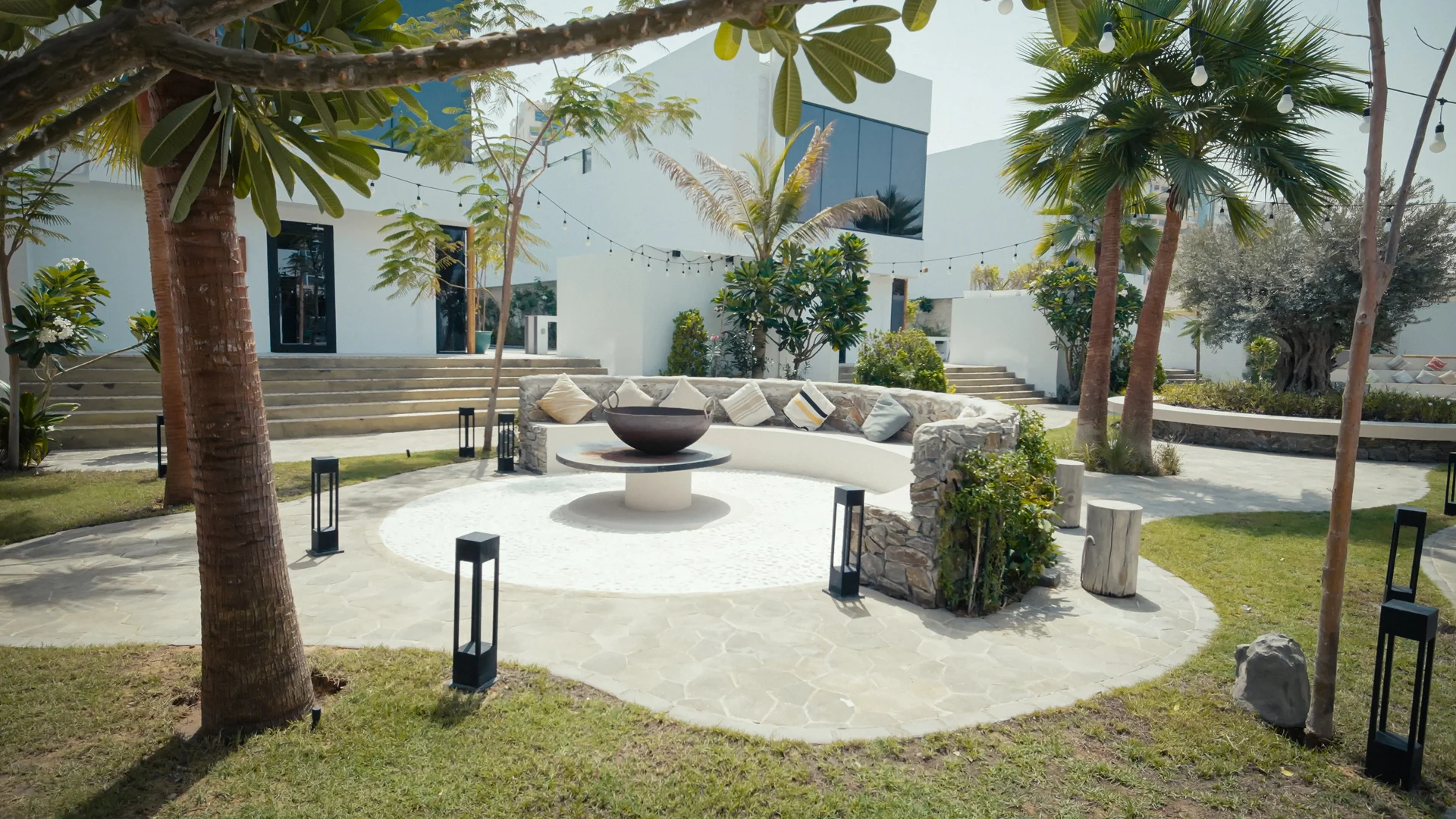 NAS House outdoor circular seating around a fire feature.