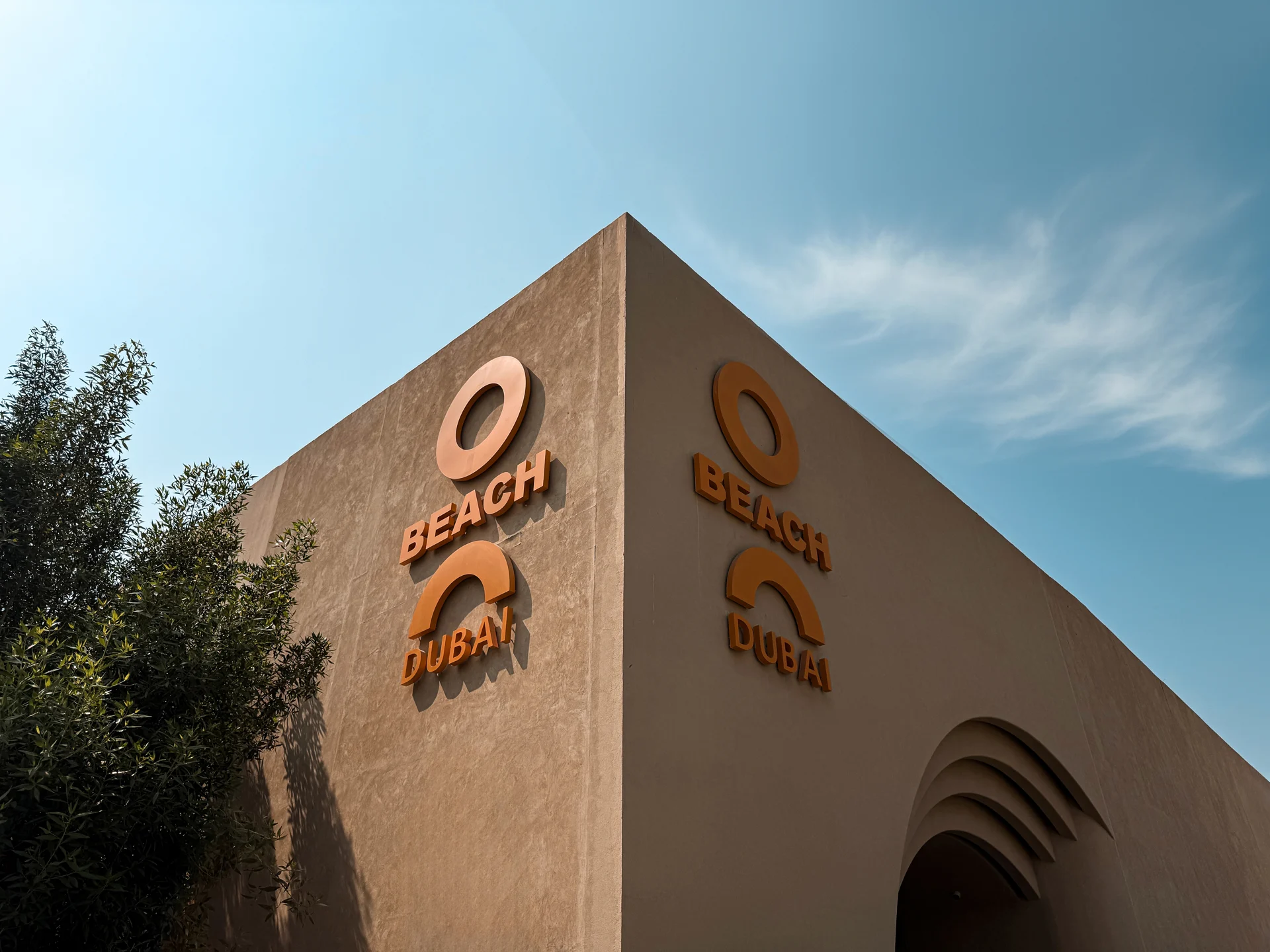 O Beach Dubai exterior sign and entrance landscaping.