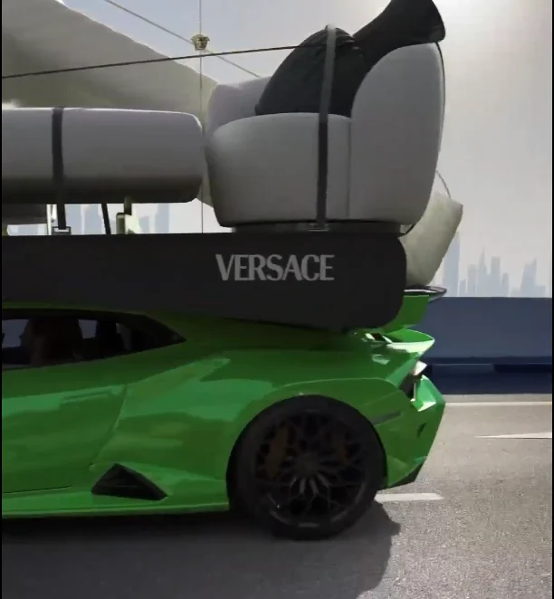Close-up of Lamborghini carrying Versace Home furniture on a Dubai road.