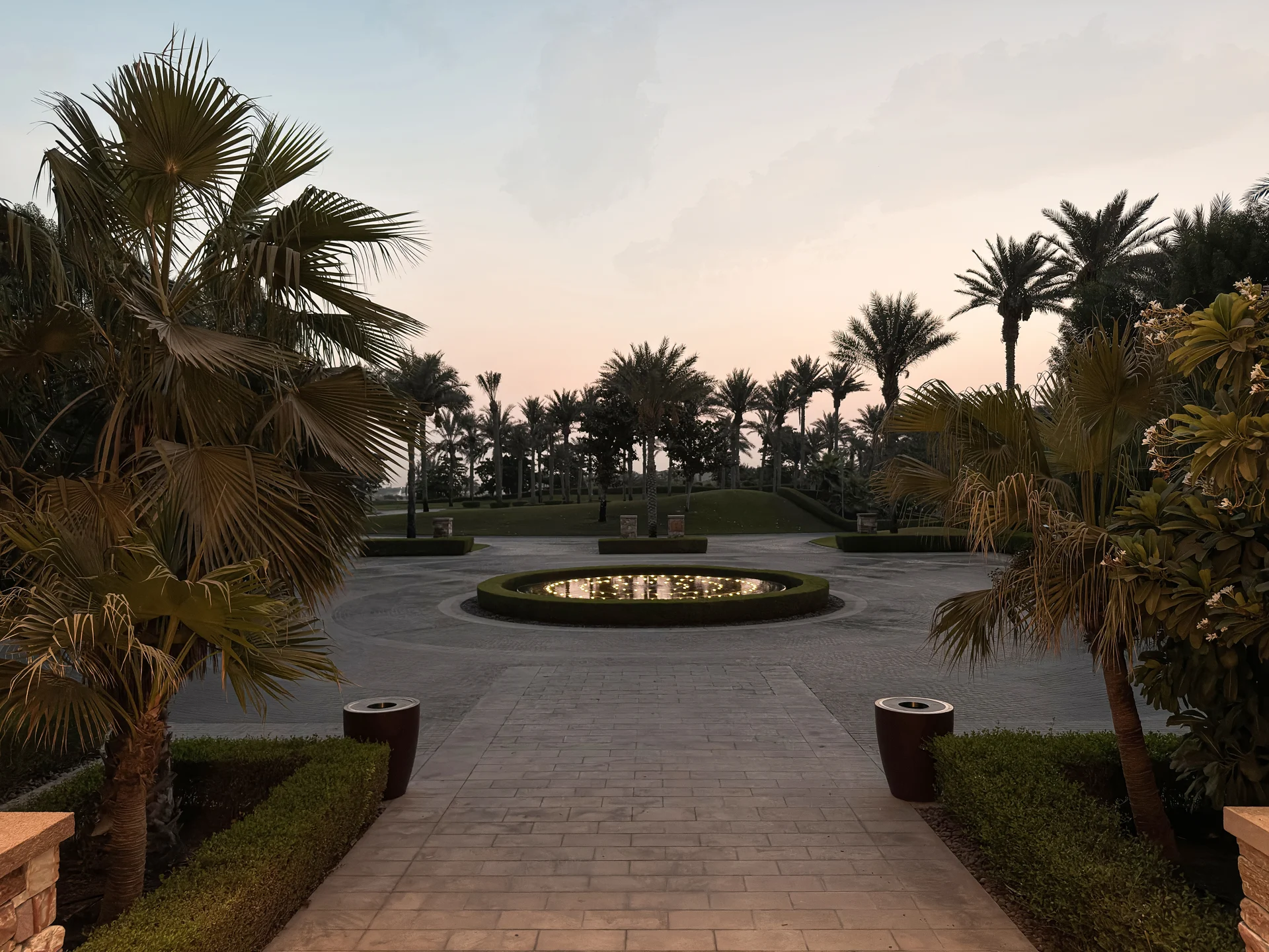 Arrival courtyard with palms and fountain at Saadiyat Beach Golf Club.
