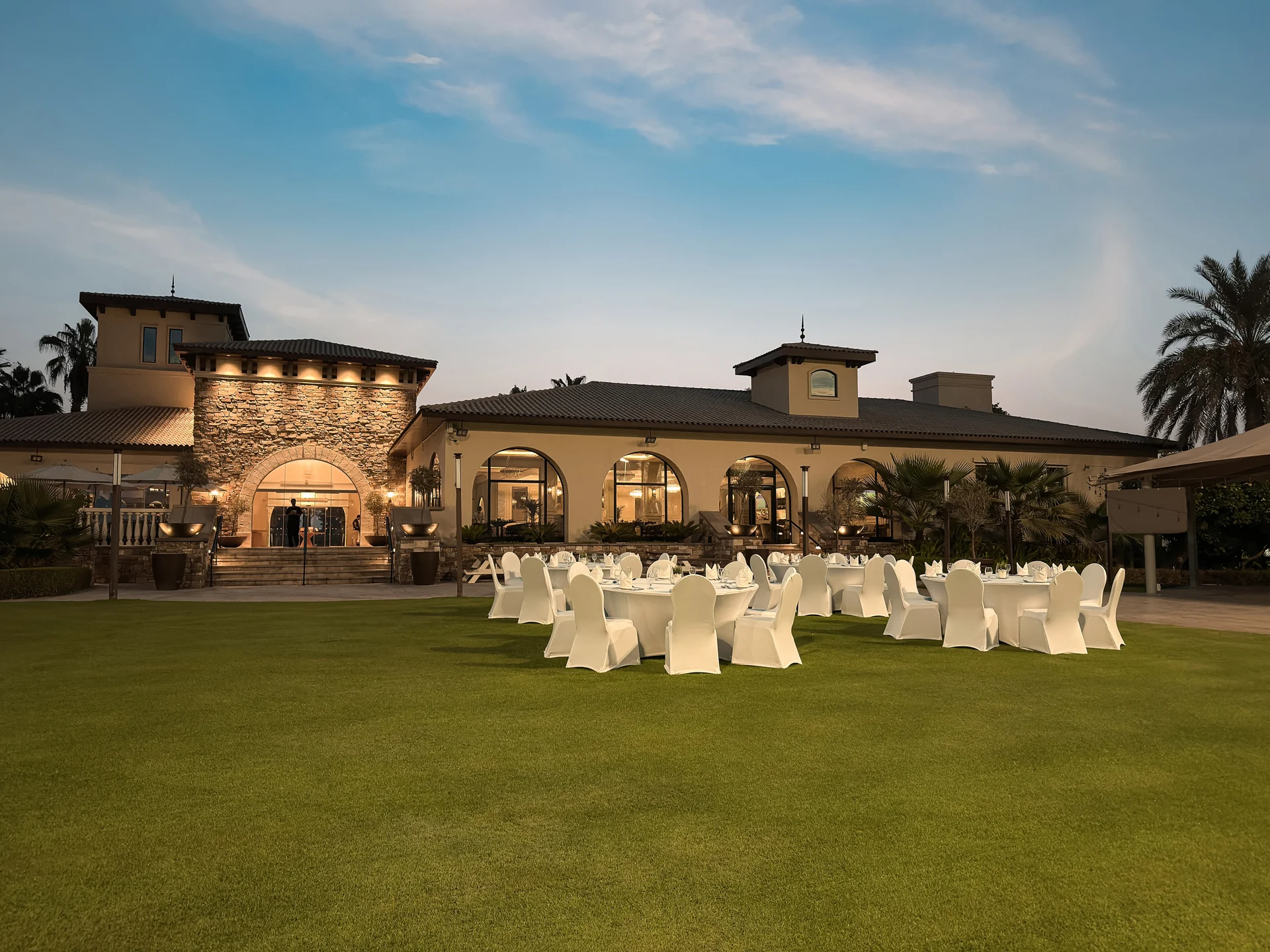 Wide outdoor event setup on the lawn at Saadiyat Beach Golf Club.