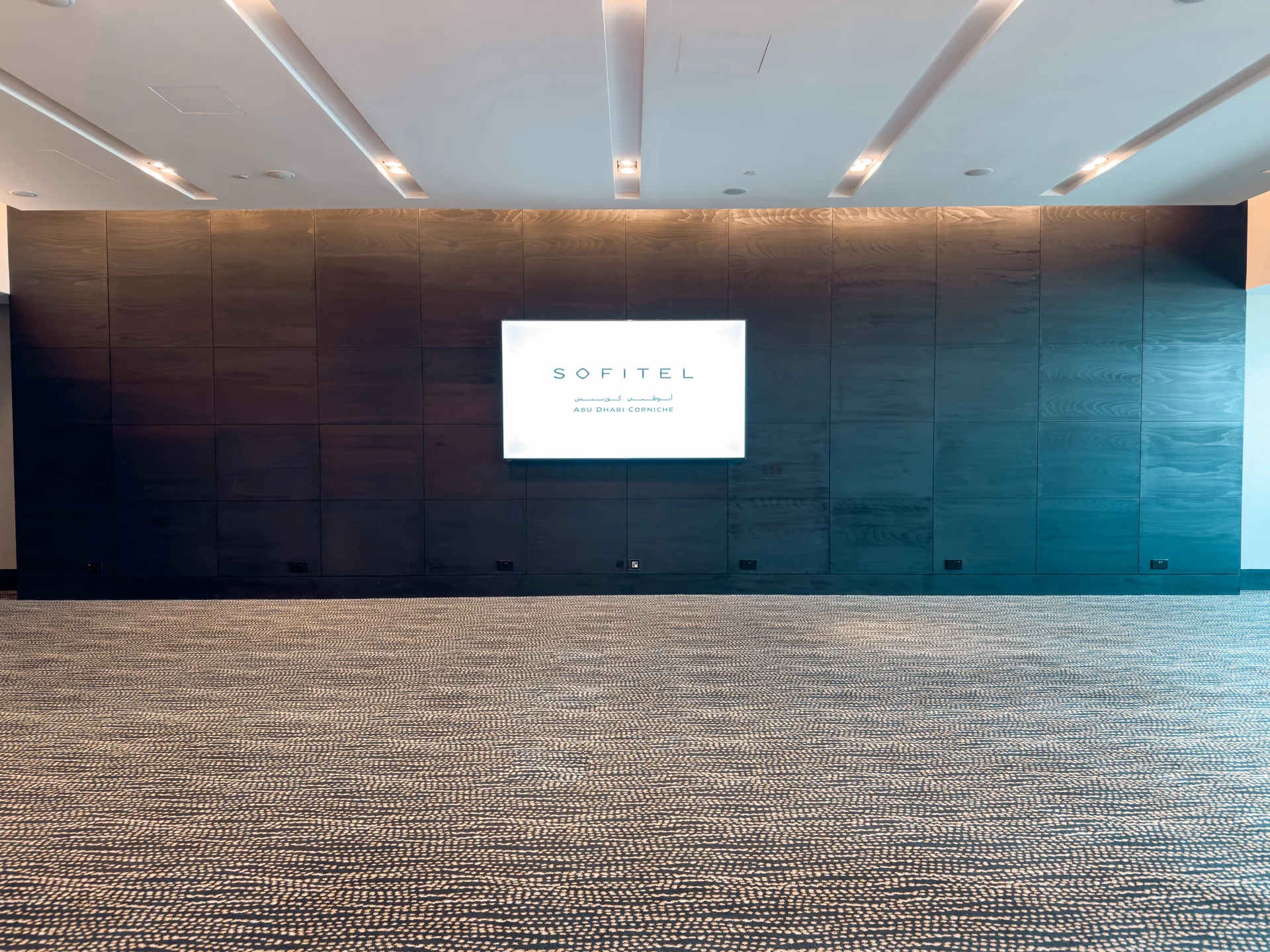 Meeting room with presentation screen at Sofitel Abu Dhabi Corniche.